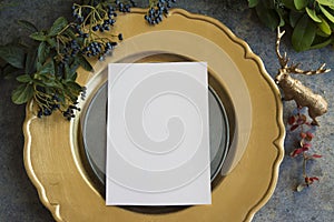Gold place setting with empty menu on grunge