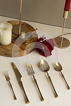 Gold plate. Cutlery set. Fork, spoon, knife, dessert fork, teaspoon. Fashion photo shoot.