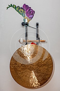 Gold plated Asian gong. Tibetan religious objects for meditation and alternative medicine
