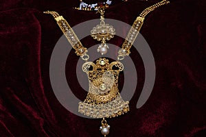 Gold plated jewelry -Fancy Designer golden long neck-set and head accessory closeup macro image
