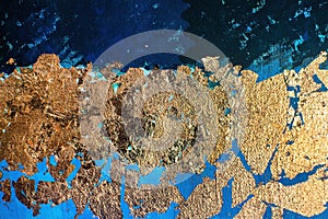 Gold-plated potal on blue textured canvas. Creative art on blue background.