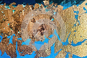 Gold-plated potal on blue textured canvas. Creative art on blue background.