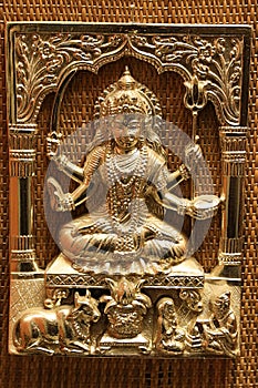 Gold plated steel embossed anaglyph picture of hinduistic god Shiva with trident called trishula and sword