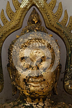 Gold plates on face buddha,The Buddha statue to gild with gold l photo