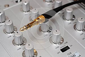 Gold plug on dj music mixer