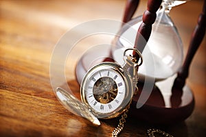 Gold pocket watch and hourglass photo