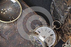 Gold pocket watch Pavel Bure on a gold pendant. Royal Russia. pocket watch on a dark background with books.