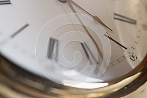 Gold pocket watch Pavel Bure on a gold pendant. Royal Russia. pocket watch on a dark background with books.