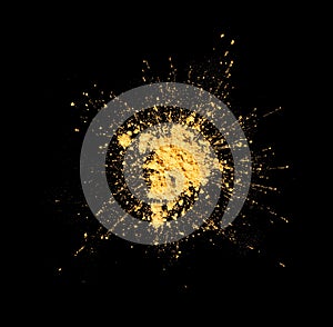 Gold powder explosion, splash isolated on black background, top view. Explosion of golden sand