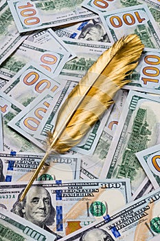 Gold quill pen on dollar money background