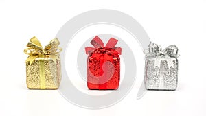 Gold, red, and silver gift box on a white background