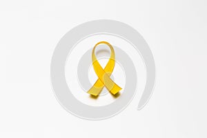 gold ribbon as symbol of childhood cancer awareness isolated on