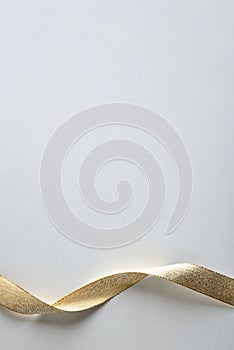 Gold ribbon with ripples at the bottom on white background
