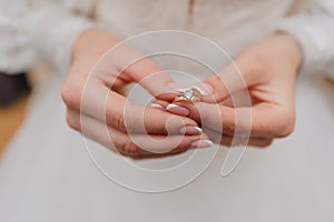 Gold ring with a diamond in the hands of the bride. Gold ring with moissanite in woman& x27;s hands