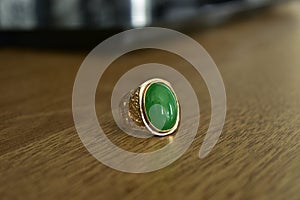 Gold ring with green inset jewel