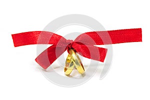Gold rings tied with red ribbon
