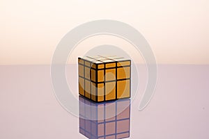 Gold Rubik`s Cube on mirrorless background