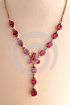 Gold ruby necklace on a jewelry stand. luxury jewelry