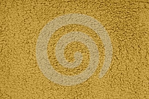 Gold sherpa textured plush fabric material background