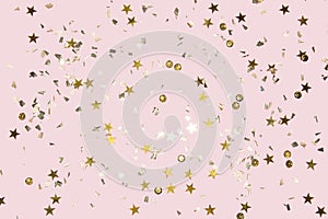 Gold shiny flying confetti on a pink background festive backdrop