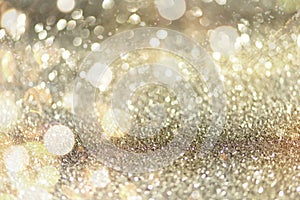 Gold and silver abstract bokeh lights. Shiny glitter background with copy space. New year and Christmas concept. Sparkling