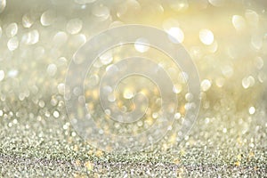 Gold and silver abstract bokeh lights. Shiny glitter background with copy space. New year and Christmas concept. Sparkling