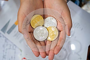 Gold and silver Bitcoins holding in hand, virtual manry and cryptocurrency concept