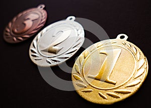Gold silver and bronze medal, medal set, black background, dark edit space photo