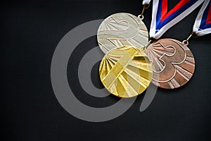 Gold silver and bronze medal, medal set, medal ceremony concept photo, black background, dark edit space