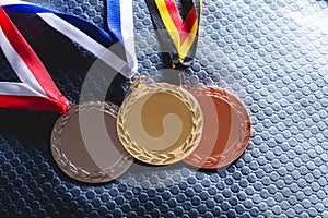 Gold, silver and bronze medal on velvet cushion