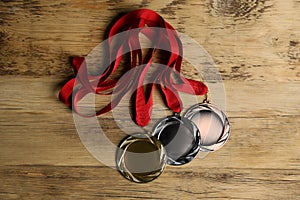 Gold, silver and bronze medals on background, flat lay. Space for design