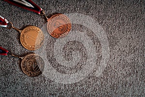 Gold, silver and bronze medals with numbers on black isolated background for winners