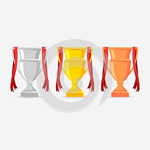 Gold, Silver and Bronze Trophy Cup with red ribbon. Cups for winners.