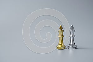 Gold and silver Chess King figure on Chessboard against opponent or enemy. Strategy, Conflict, management, business planning,