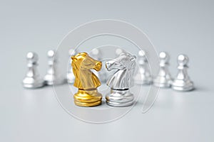 Gold and silver Chess Knight horse figure against pawn. Strategy, Conflict, management, business planning, tactic, politic,