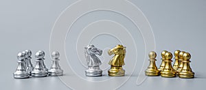 Gold and silver Chess Knight horse figure on Chessboard against opponent or enemy. Strategy, Conflict, management, business