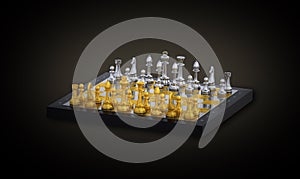 Gold and silver chess pieces on a black chessboard over the black background