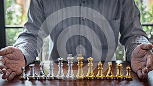 Gold and silver chess with player, Intelligent businessman playing chess game competition to planning business strategic to