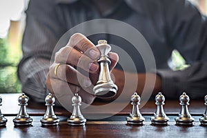 Gold and silver chess with player, Intelligent businessman playing chess game competition to planning business strategic to