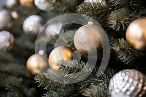 gold and silver christmas ornaments on a christmas tree
