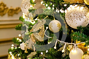 Gold and silver Christmas toys, balls and garlands on a spruce branch on christmas tree