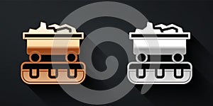 Gold and silver Coal train wagon icon isolated on black background. Rail transportation. Long shadow style. Vector