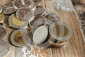 Gold, silver coins on the wooden background