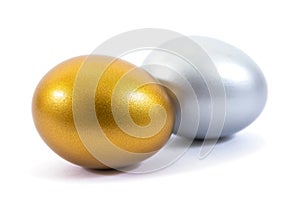 Gold and silver eggs isolated on white background. Silver and gold eggs isolated