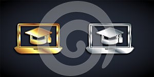 Gold and silver Graduation cap on screen laptop icon isolated on black background. Online learning or e-learning concept