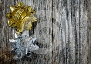 Gold and Silver Holiday Bow on Rustic Wood