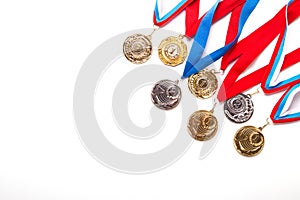 Gold and silver medals with ribbon on white background.