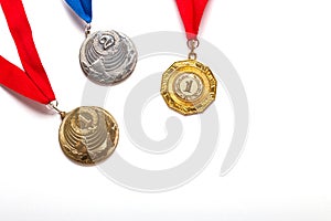 Gold and silver medals with ribbon on white background.