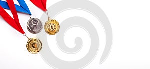 Gold and silver medals with ribbon on white background