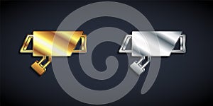 Gold and silver Security camera icon isolated on black background. Long shadow style. Vector